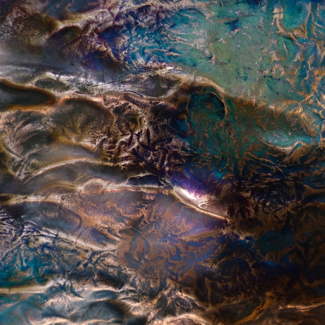 Flame patina across hammered copper, detail